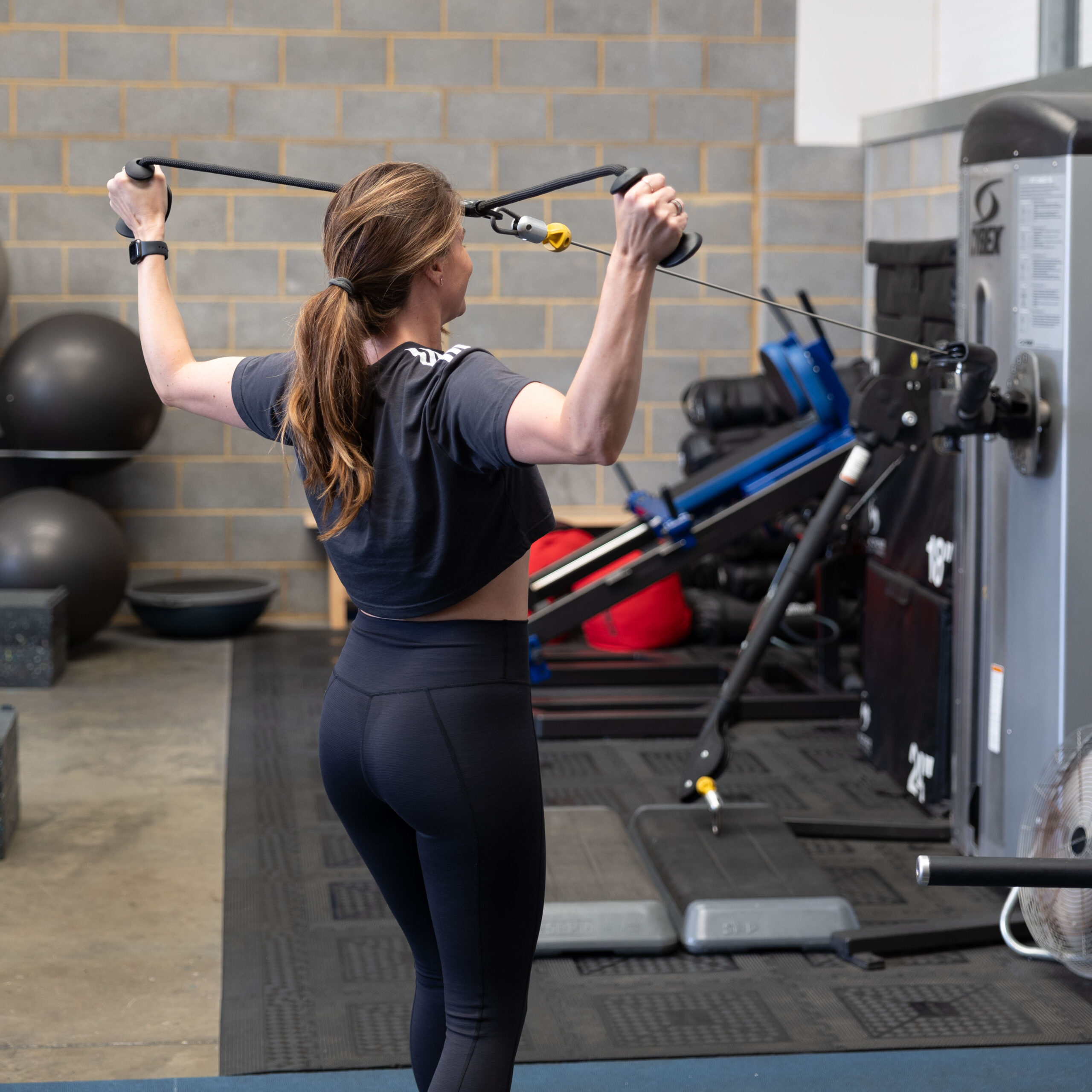 Woman using weight machine